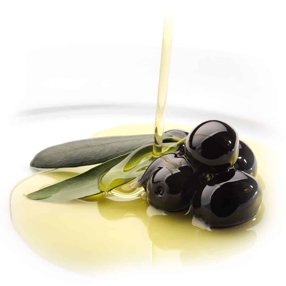 high phenolic olive oil being poured on black olives high phenolic olive oil being poured on black olives